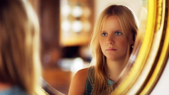woman looking in mirror feeling ugly husband won't touch