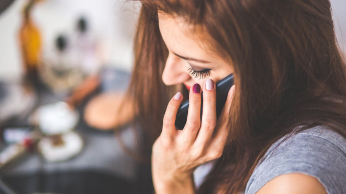 woman talking on phone about her relationship triangulation